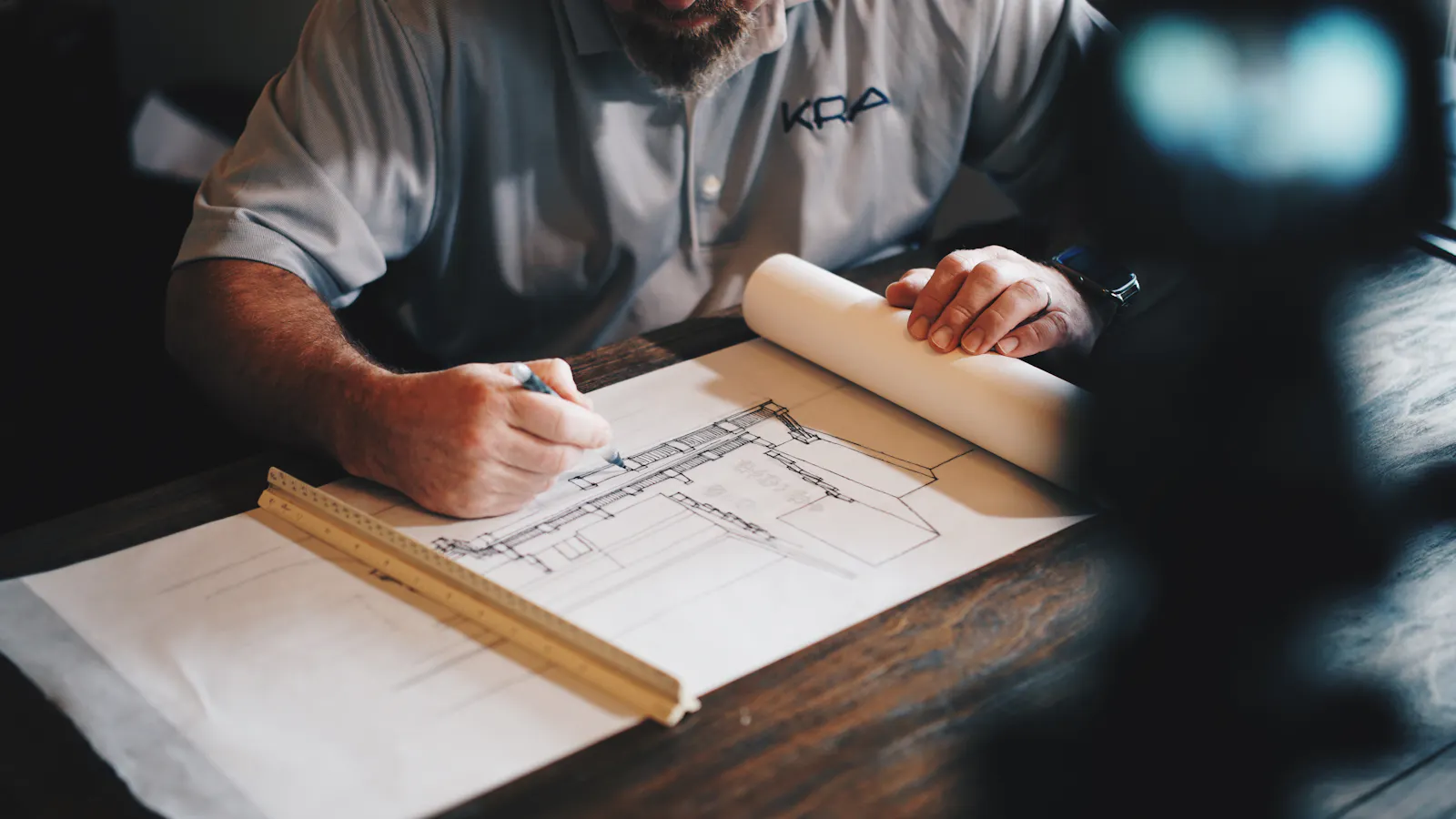 Architect drafting a drawing with a pencil and ruler